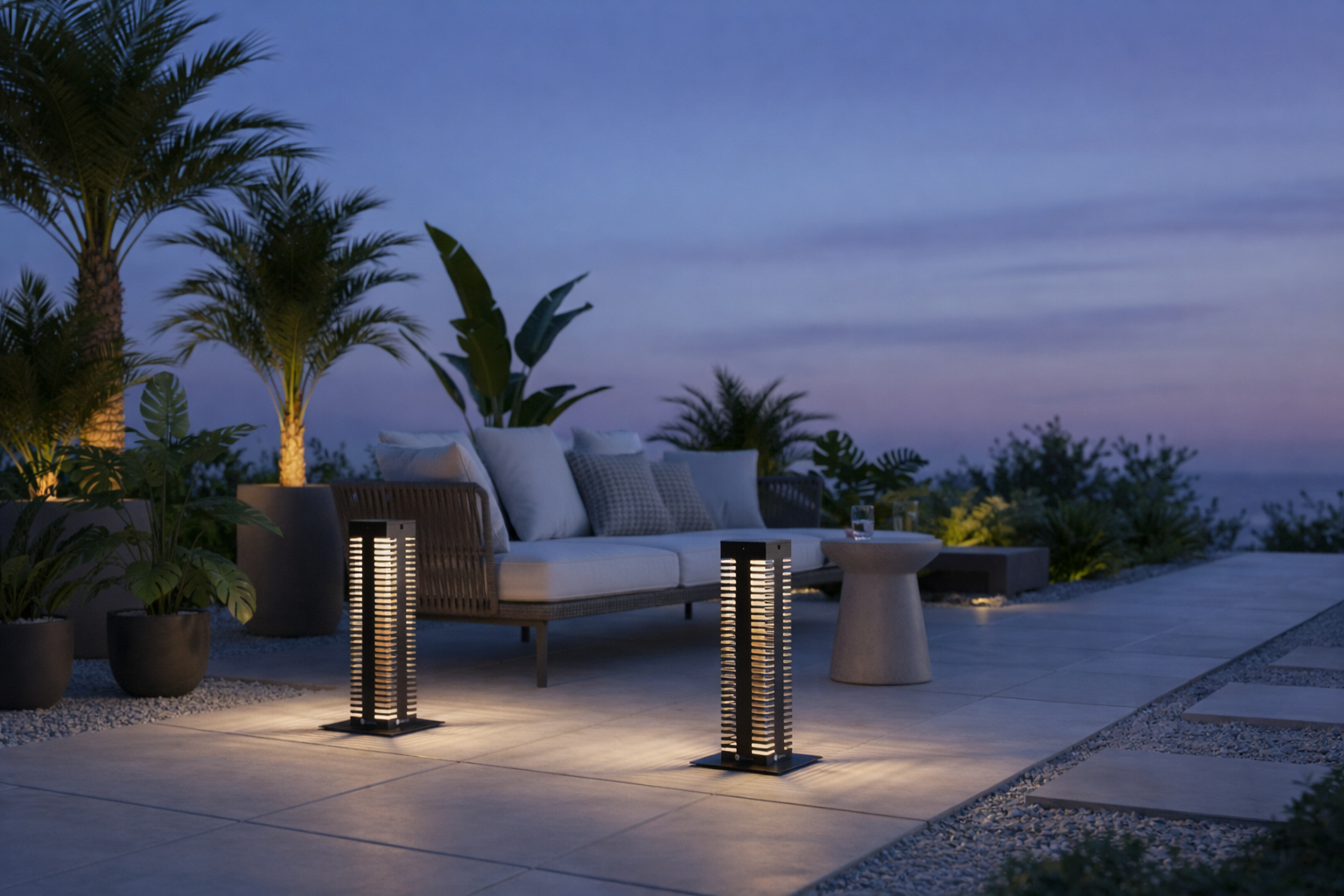 Contemporary outdoor solar lanterns emitting warm light on a modern patio, styled with lounge seating, tropical plants, and ambient evening lighting.